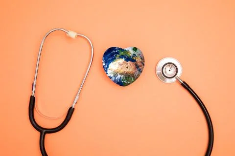 Stethoscope with globe on a red background.Headline Stock Photos