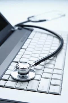 Stethoscope on laptop Stock Photos