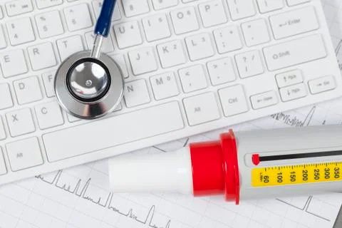 Stethoscope laying on a white computer keyboard Stock Photos