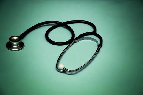 A stethoscope on a light green gradient background. Stock Photos