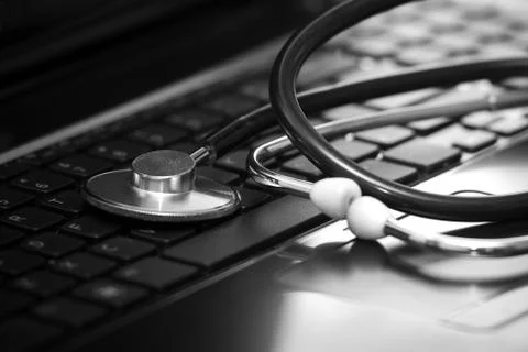Stethoscope lying down on an laptop Foto stock
