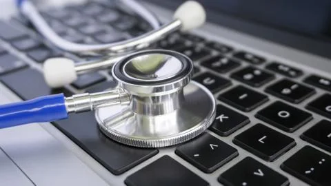 Stethoscope Lying on Top of Laptop Computer Keyboard Stock Photos