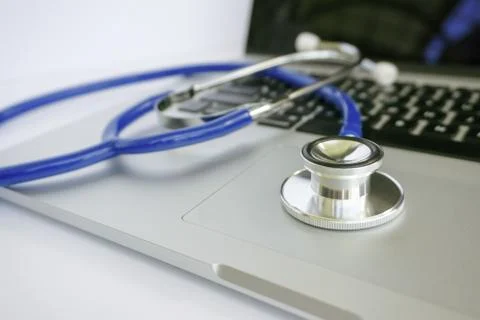 Stethoscope Lying on Top of Laptop Computer Stock Photos