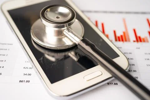 Stethoscope with mobile phone on graph paper, Finance, Account, Statistics,.. Stock Photos