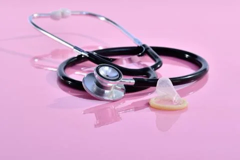 Stethoscope next to a generic rubber condom Stock Photos