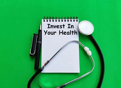 Stethoscope, pen and note printed invest in your health, health care concept Stock Photos