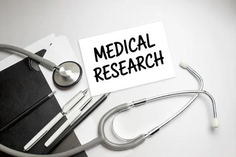 Stethoscope, pens and note with text MEDICAL RESEARCH Stock Photos