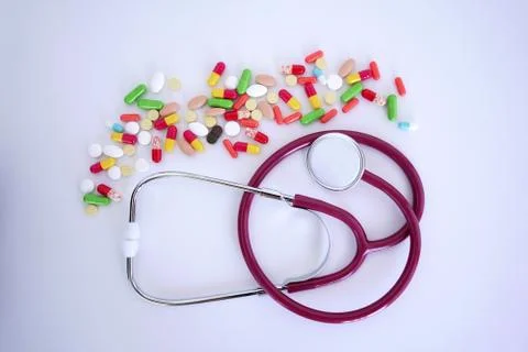Stethoscope, phonendoscope and a bundle of tablets isolated on a white Stock Photos