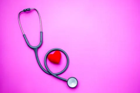 Stethoscope on a pink background with space for text. Stock Photos