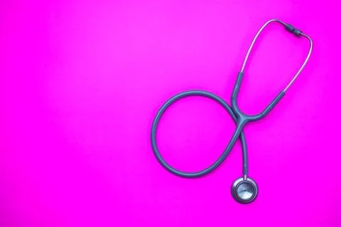Stethoscope on a pink background with space for text. Stock Photos