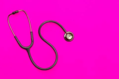 Stethoscope on a pink background with space for text. Stock Photos