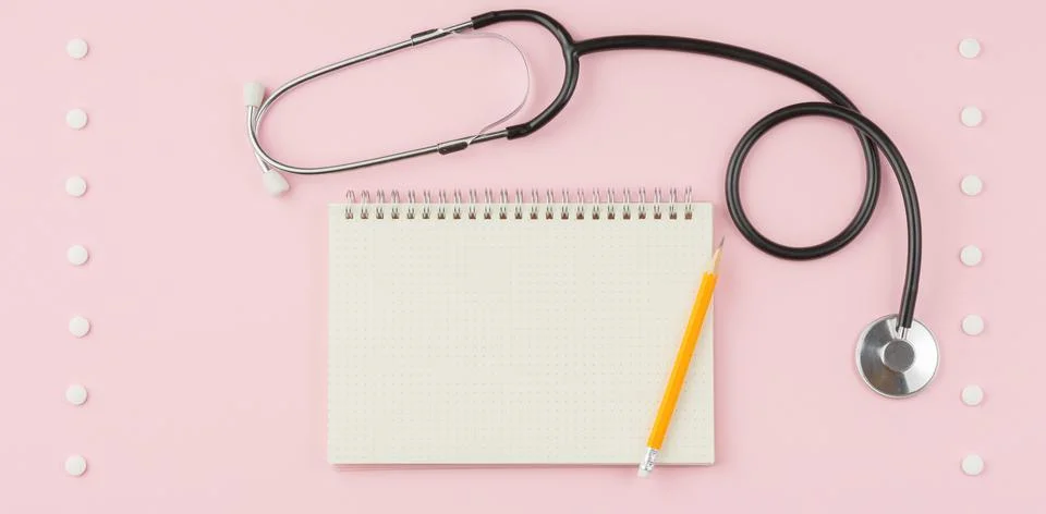 Stethoscope on a pink table. Stock Photos