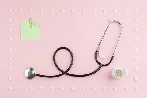 Stethoscope on a pink table. Stock Photos