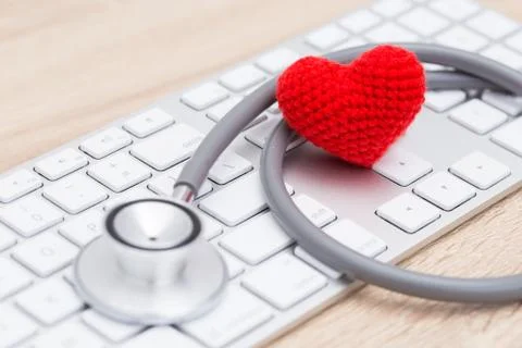 Stethoscope with red heart on keyboard Foto stock