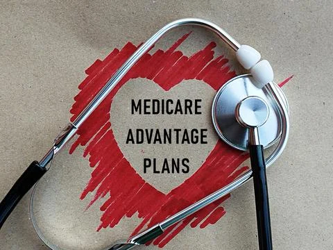 Stethoscope with red heart shape shadow and medicare advantage plans writing Foto stock