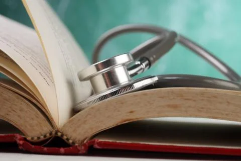 Stethoscope resting on the book Stock Photos
