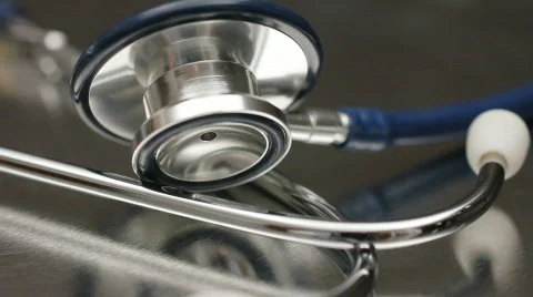 Stethoscope rotating on a metal surface Stock Footage