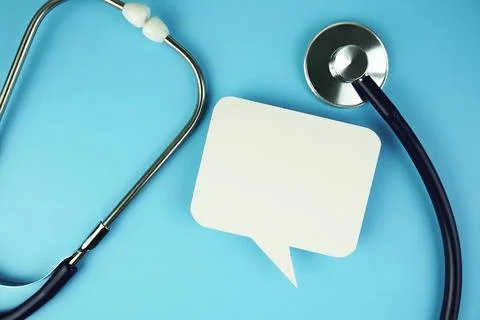 Stethoscope with speech bubble top view on blue background, health and busi.. Stock Photos