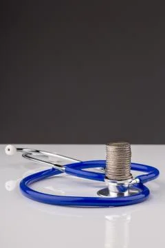 Stethoscope with a stack of coins Stock Photos