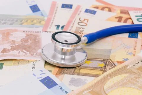 Stethoscope on a stack of euro bank notes Stock Photos