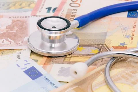 Stethoscope on a stack of euro bank notes Stock Photos