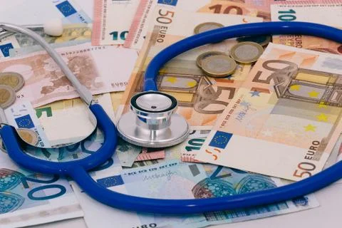 Stethoscope on a stack of euro bank notes Stock Photos