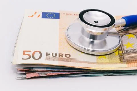 Stethoscope on a stack of euro bank notes Stock Photos