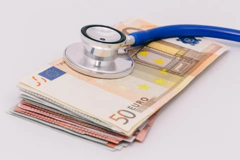 Stethoscope on a stack of euro bank notes Stock Photos