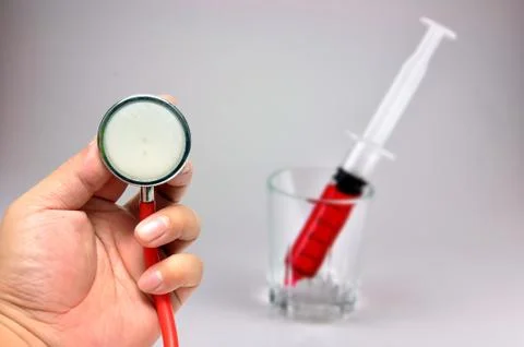 Stethoscope with syringe Stock Photos