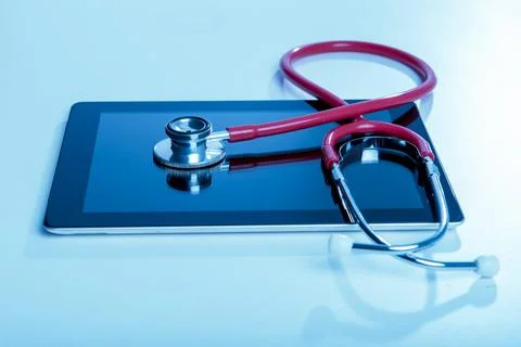 Stethoscope with tablet computer on blue background Stock Photos
