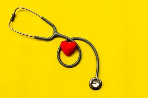 Stethoscope on a yellow background with space for text. Foto stock