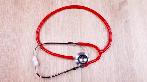 Stethoscope's on the table. The doctor's red stethoscope. Stock-Footage 299727900