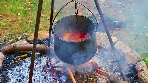 Stew camp fire cauldron camping. Outdoor cooking. Video stock 96543217