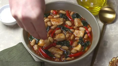 Stew with chicken, beans, spinach, peppers, tomatoes, and onions. Healthy eating Vídeo Stock 325976501
