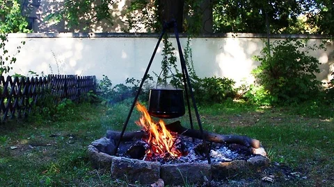 Stew fire cokking in garden Stock Footage 98790174