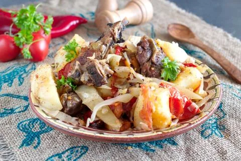 Stew with lamb chops and vegetables: onion, cabbage, potato, tomato, paprika Stock Photos