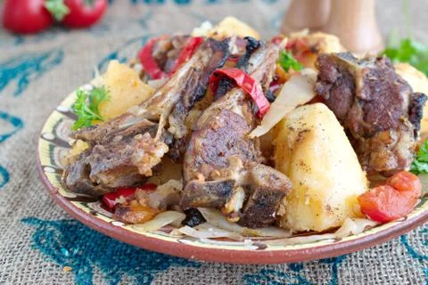 Stew with lamb chops and vegetables: onion, cabbage, potato, tomato, paprika Stock Photos