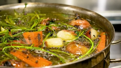 A stew of leaf vegetables and meat cooking in a pot on the stove Stock Footage 264310533