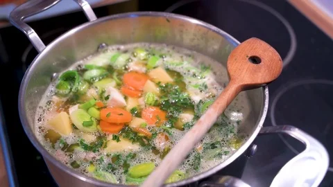 Stew with vegetables is cooking in a saucepan 2 Stock Footage 124680063