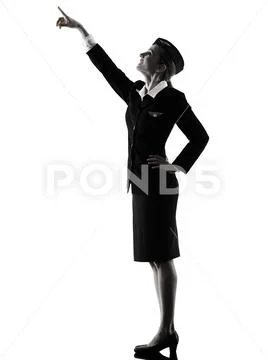Stewardess cabin crew woman pointing silhouette Stock Photos