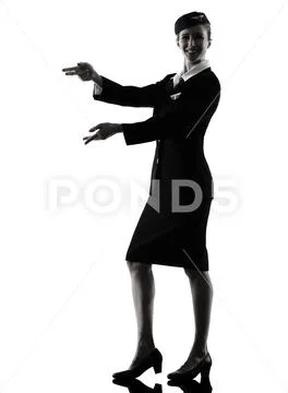 Stewardess cabin crew woman pointing silhouette Stock Photos