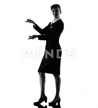 Stewardess cabin crew woman pointing silhouette Stock Photos