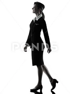 Stewardess cabin crew woman walking isolated silhouette Stock Photos