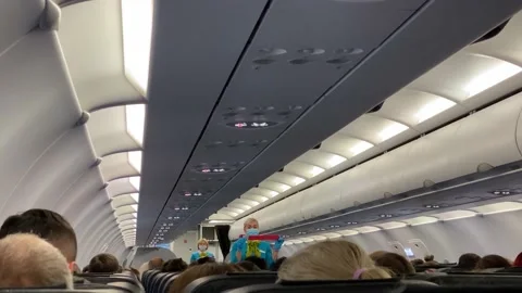Stewardess explains how to use the seat belt Stock Footage 139745219