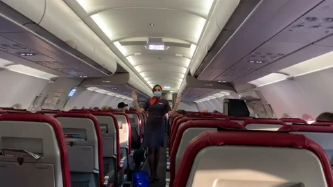 Stewardess explains to passengers where the exits are located Stock-Footage 139745476