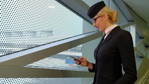 Stewardess is reading a message on your smartphone and smiles Stock Footage 71634253