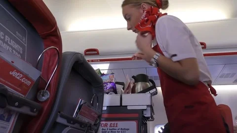 Stewardess serving drinks on board of aircraft Vídeos de archivo 83874744