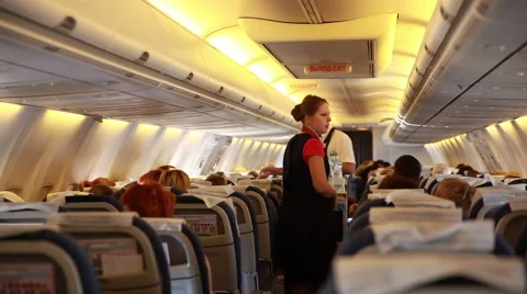 Stewards serve passengers on the plane. Stock Footage 42523034