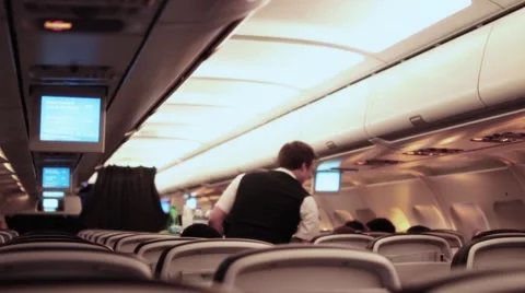 Stewards serving airline meal during flight - 1080p Stock Footage 64337269