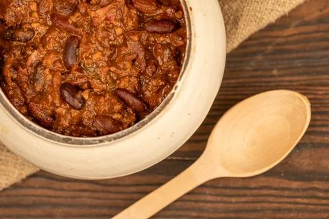 Stewed beans with meat in a small pot. A traditional rustic dish. Close-up, s Stock Photos